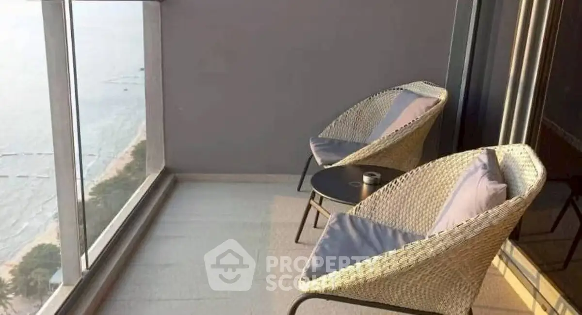 Stunning balcony with ocean view and cozy seating area