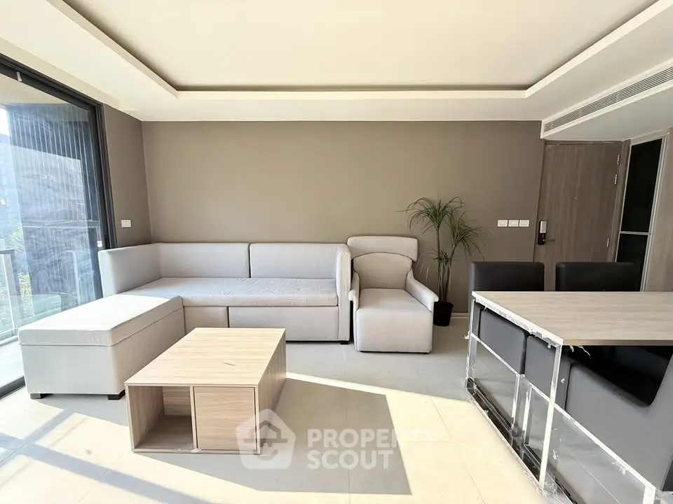 Modern living room with sleek furniture and abundant natural light