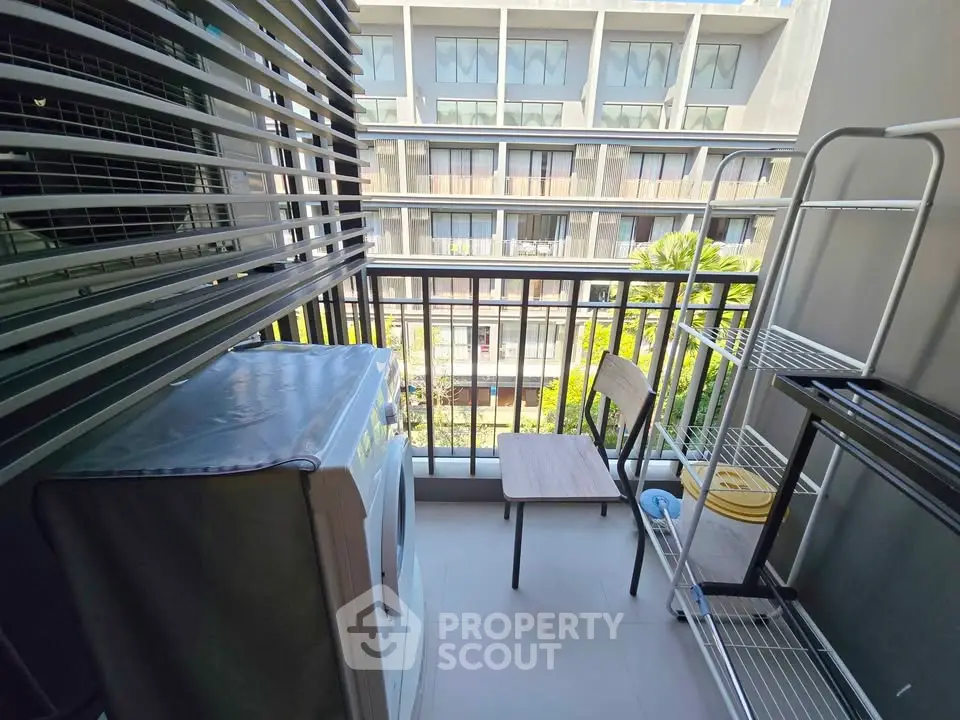 Charming balcony with laundry area and city view, perfect for urban living.