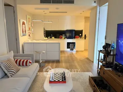 Modern open-layout living room with stylish kitchen and cozy seating area, perfect for urban living.