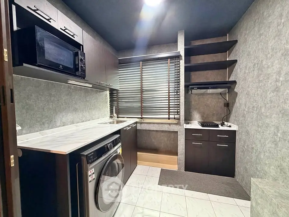 Modern kitchen with sleek appliances and stylish cabinetry in a contemporary home.