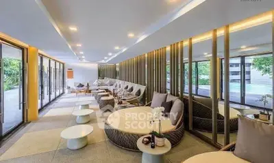 Luxurious modern living room with elegant seating and floor-to-ceiling windows overlooking greenery.