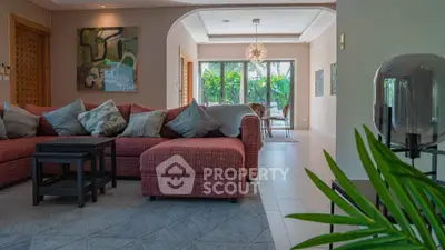 Spacious living room with modern decor and garden view, perfect for family gatherings.