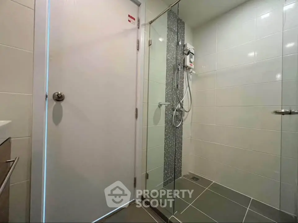 Modern bathroom with glass shower and sleek tile design