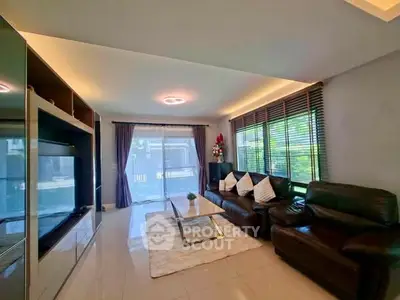 Spacious living room with modern decor and large windows for natural light.