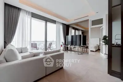 Luxurious living room with modern decor and large windows offering stunning city views.