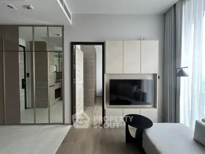 Modern living room with sleek TV unit and large windows