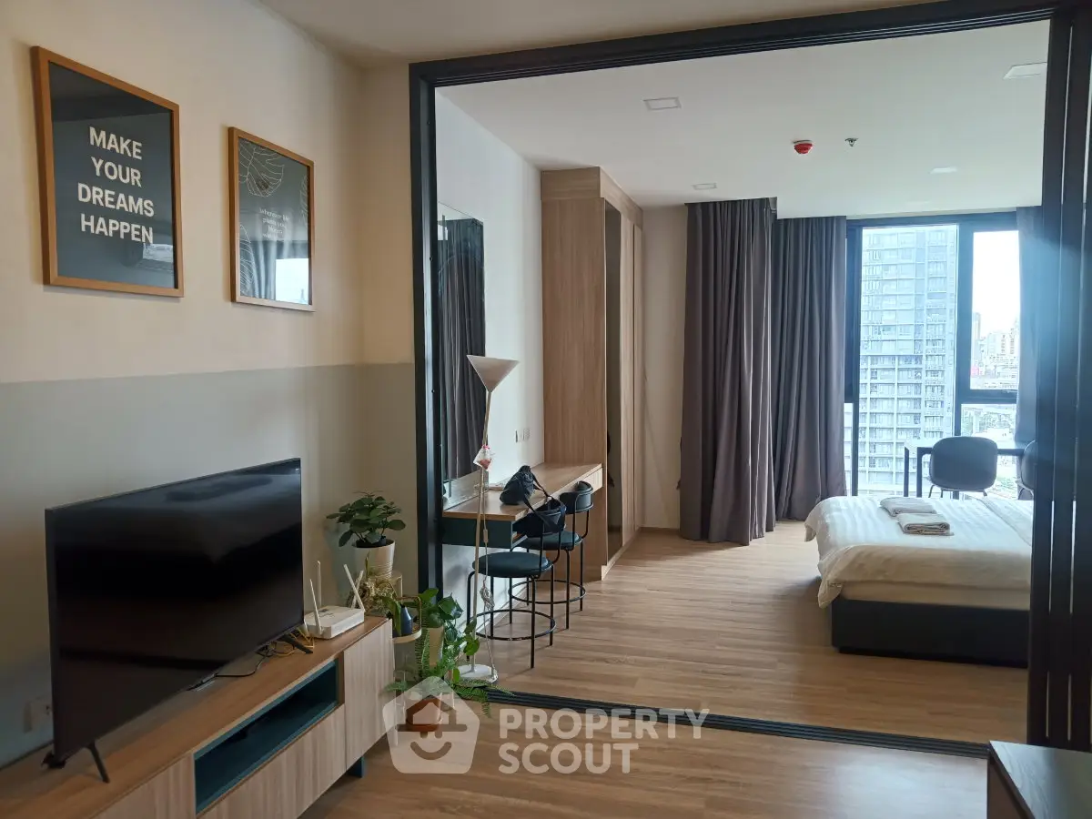 Modern studio apartment with open layout, featuring a cozy living area and stylish bedroom with city view.