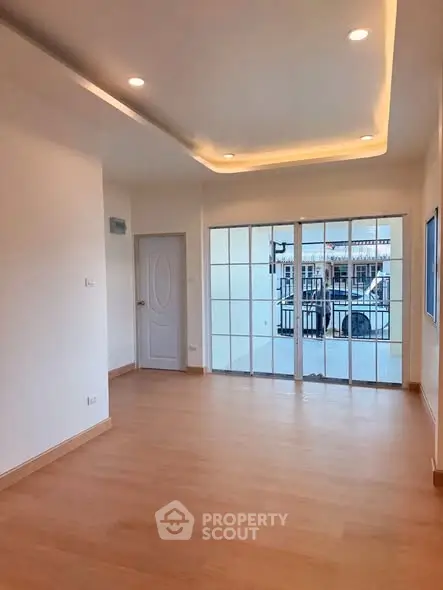 Spacious modern living room with wooden flooring and large windows