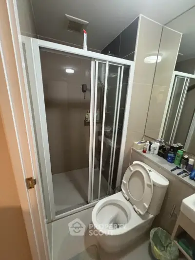 Modern bathroom with glass shower and sleek fixtures, ideal for contemporary living.