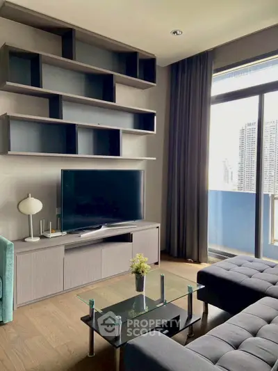 Modern living room with sleek furniture and city view from large window.