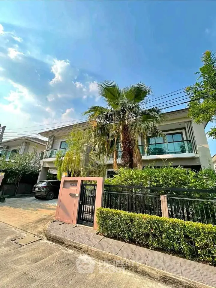 Stunning modern house with lush greenery and spacious driveway in a serene neighborhood.