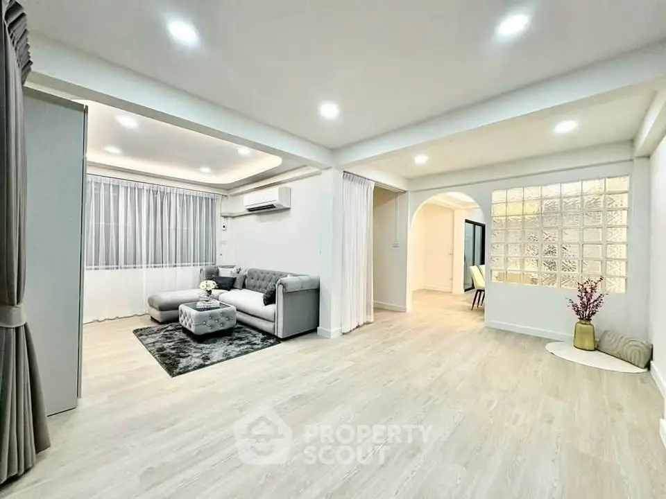 Spacious modern living room with elegant decor and ample natural light