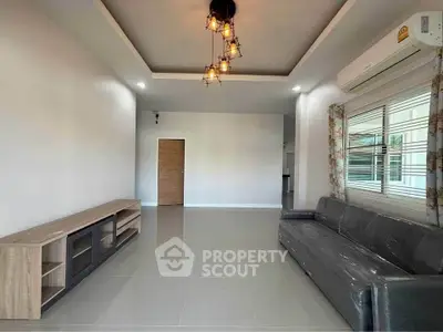 Spacious living room with modern lighting and air conditioning in a contemporary home.