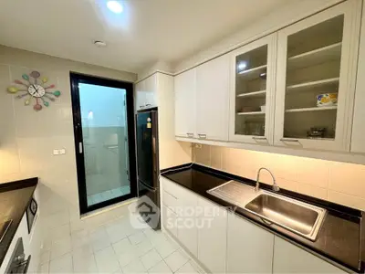 Modern kitchen with sleek cabinets and stainless steel appliances in a bright, well-lit space.
