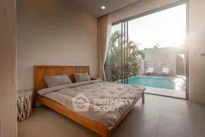 Luxurious bedroom with poolside view and modern decor