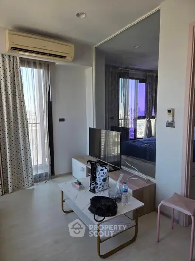 Modern living room with air conditioning and stylish decor in a high-rise apartment.