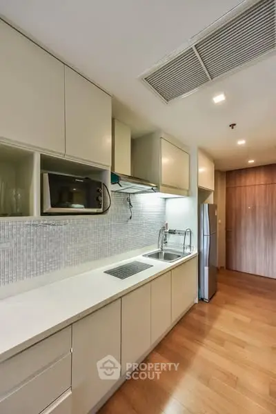 Modern kitchen with sleek cabinetry and built-in appliances
