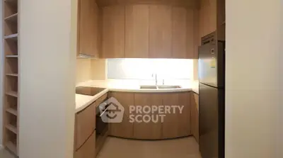 Modern kitchen with sleek wooden cabinets and built-in appliances