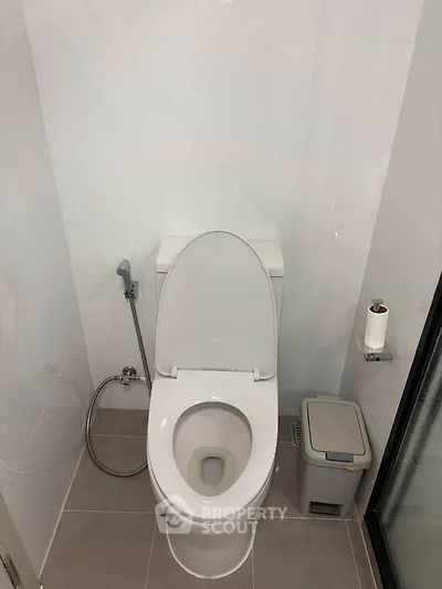 Modern bathroom with sleek toilet and minimalistic design, perfect for contemporary living spaces.