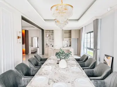 Luxurious dining room with elegant chandelier and marble table in modern home