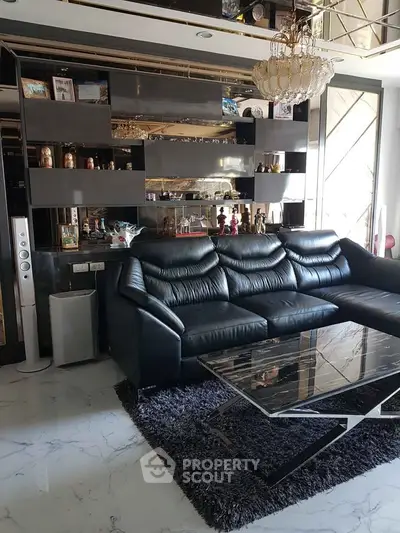 Luxurious living room with black leather sofa and modern decor