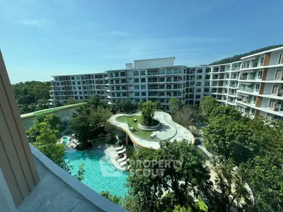 Luxurious residential complex with stunning pool and lush greenery, offering serene living environment.