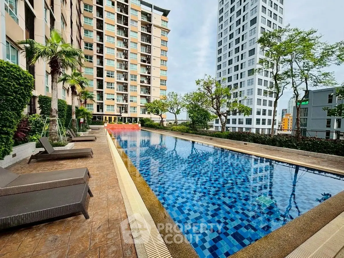 Luxurious high-rise apartment with stunning pool and lush greenery, perfect for urban living.