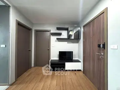 Modern living room with sleek wooden flooring and stylish TV unit