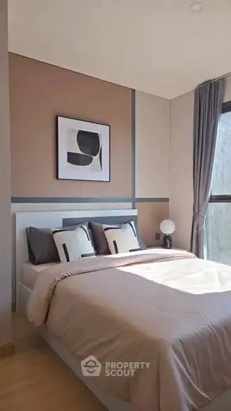 Modern bedroom with stylish decor and natural light, featuring a cozy bed and elegant curtains.