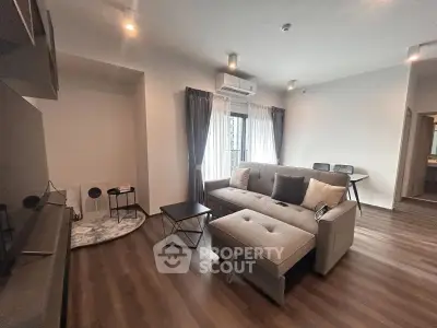 Modern living room with stylish furniture and natural light, perfect for relaxation and entertainment.