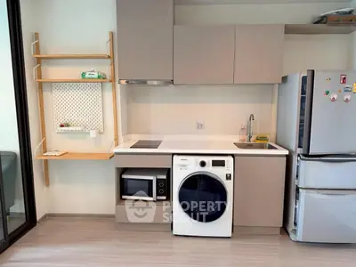 Modern kitchen with integrated appliances and sleek cabinetry in a stylish apartment.