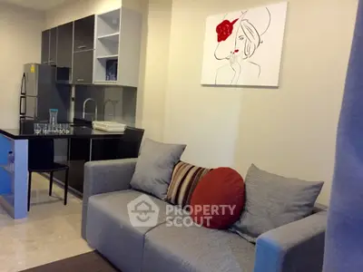Modern living room with stylish kitchen and elegant decor in a cozy apartment.
