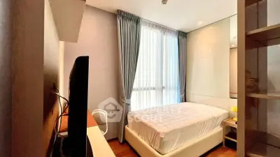 Cozy modern bedroom with large window and stylish decor