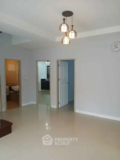 Spacious modern living room with elegant lighting and tiled flooring