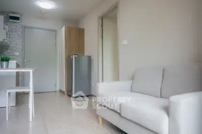 Modern apartment interior with cozy living room and compact kitchen area.