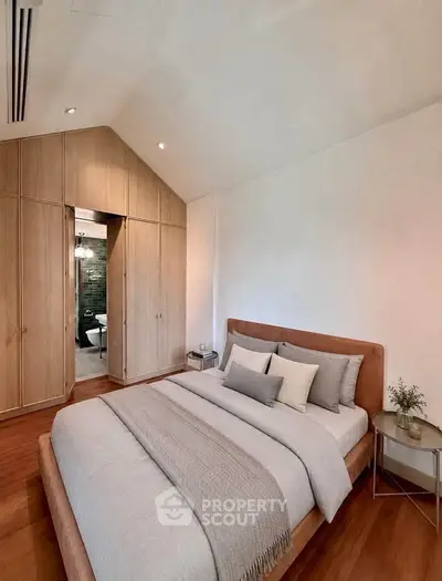 Luxurious bedroom with elegant wooden accents and plush bedding in modern home