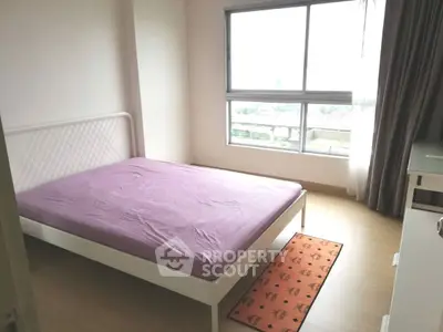 Bright bedroom with large window and minimalist decor