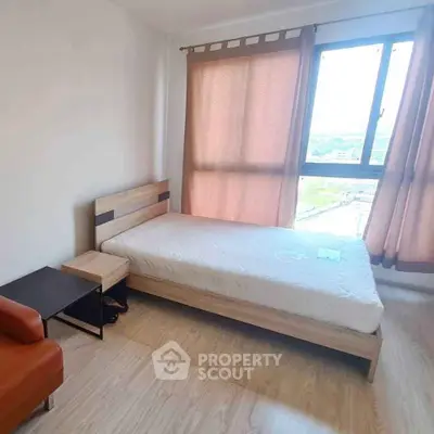 Cozy bedroom with natural light and modern furnishings, perfect for a serene living experience.