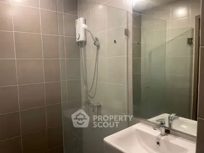 Modern bathroom with sleek tiles and glass shower enclosure