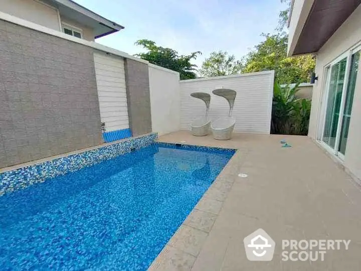 Luxurious private pool area with modern design and stylish seating