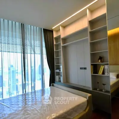 Modern bedroom with built-in shelves and large window view