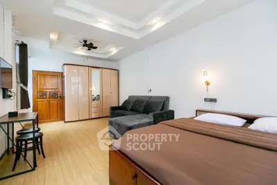 Spacious bedroom with modern design and cozy seating area