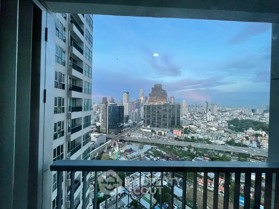Stunning cityscape view from a high-rise balcony at dusk, showcasing urban skyline and vibrant city life.