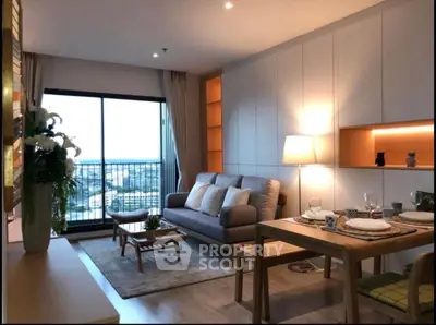 Modern living room with cozy sofa, dining area, and balcony view in stylish apartment.