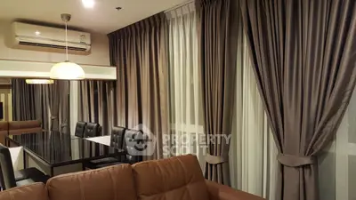 Elegant living room with modern dining area and luxurious curtains