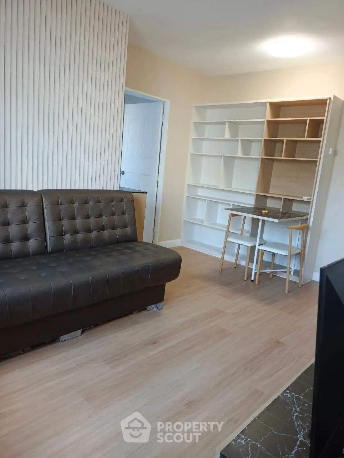 Modern living room with stylish sofa and built-in shelving, perfect for urban living.