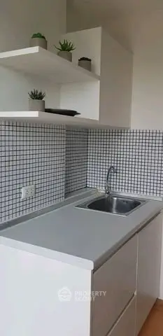 Modern kitchen with sleek white cabinetry and stylish tile backsplash