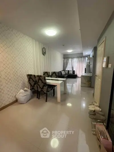 Spacious living room with elegant decor and ample natural light, perfect for relaxation and entertainment.