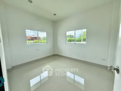 Bright empty room with large windows and glossy tiled floor, perfect for customization.
